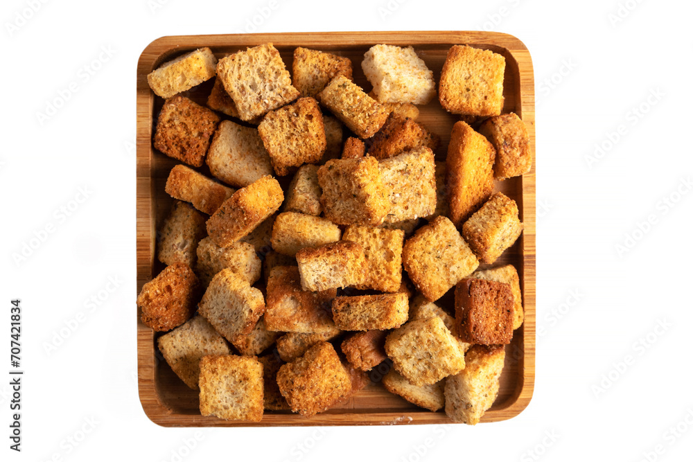 delicious crispy fried croutons in wooden bowl isolated on white delicious crispy fried croutons in wooden bowl isolated on white