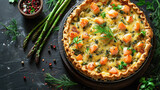 Open pie with potatoes salmon cheese and asparagus on a dark background top view
