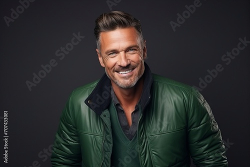 Portrait of a handsome mature man in a green leather jacket.