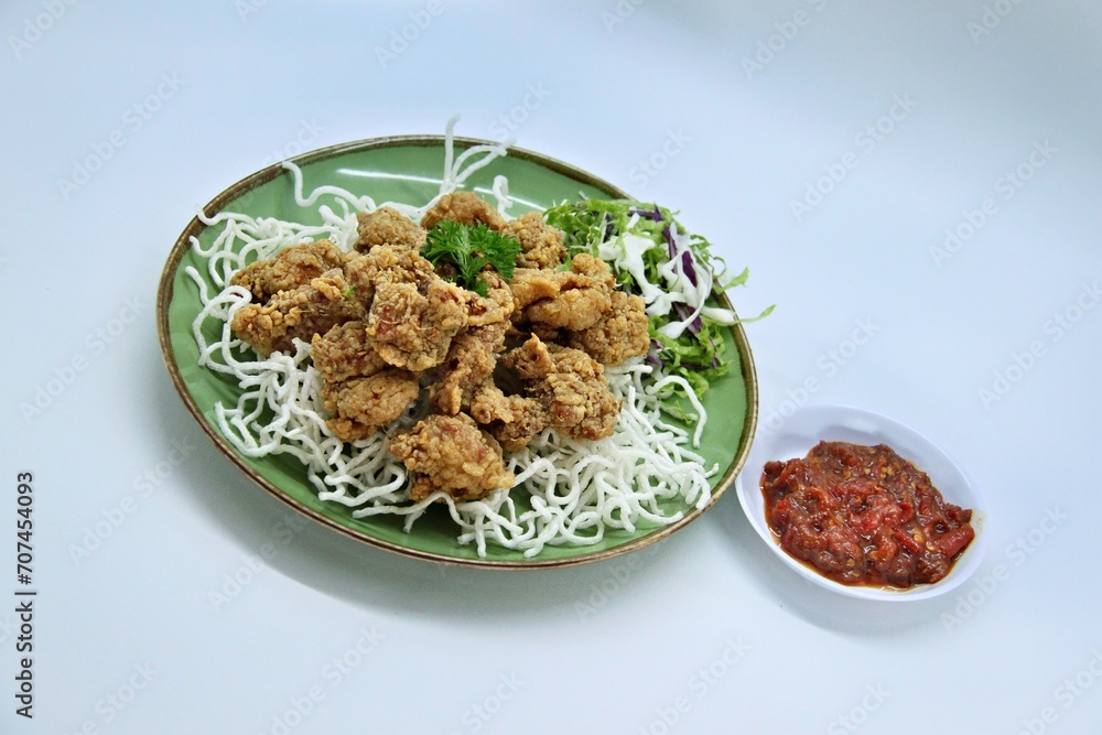 ayam goreng kering is an indonesian food crispy fried chicken with hot and spicy sambal chili sauce. delicious homemade crispy fried chicken. crunchy fried chicken ready to eat. ayam goreng kering is an indonesian food crispy fried chicken with hot and spicy sambal chili sauce. delicious homemade crispy fried chicken. crunchy fried chicken ready to eat.
