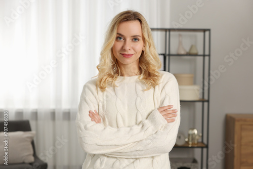 Beautiful woman in stylish warm sweater at home