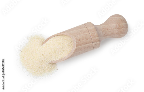 Wooden scoop with uncooked organic semolina isolated on white, top view