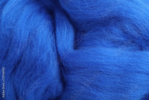 Blue felting wool as background, closeup view
