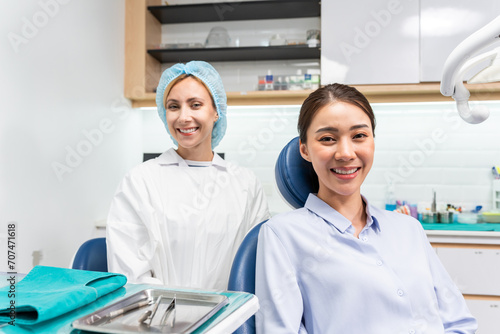 Portrait of Asian young woman patient and dentist at health care clinic.
