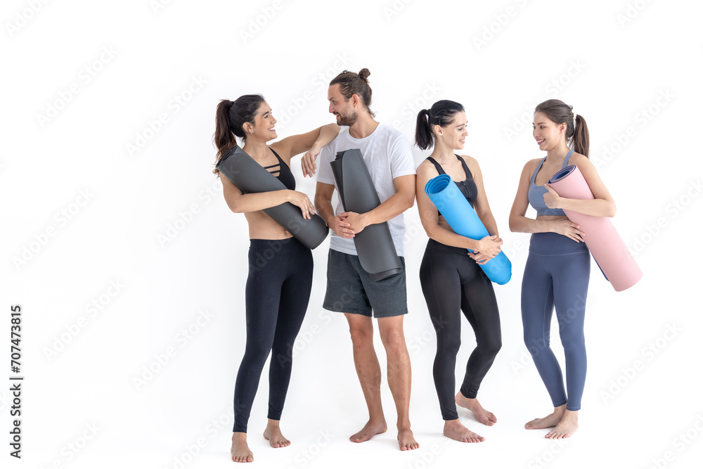 Group of happy sporty girls and guy wearing body stylish sportswear holding personal carpets leaned on a white background. waiting for yoga class or body weight class. healthy lifestyle and wellness Group of happy sporty girls and guy wearing body stylish sportswear holding personal carpets leaned on a white background. waiting for yoga class or body weight class. healthy lifestyle and wellness