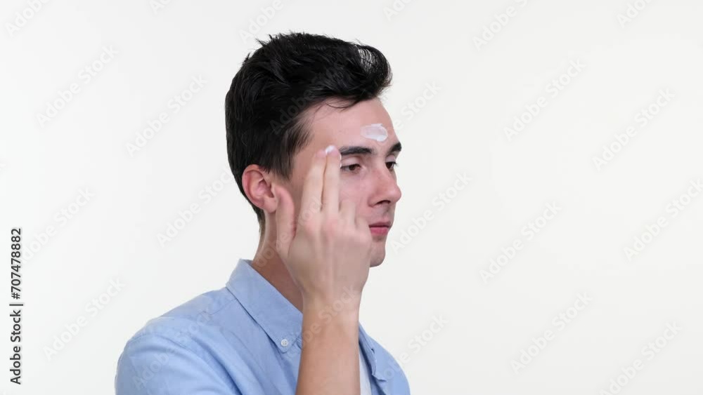 Man gently massages facial cream onto skin, expression serene and focused. His fingers move in slow, deliberate circles, delicately nourishing complexion. Man gently massages facial cream onto skin, expression serene and focused. His fingers move in slow, deliberate circles, delicately nourishing complexion.