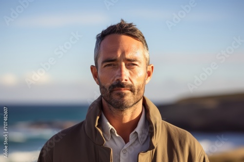 Portrait of a handsome mature man with a beard on the beach