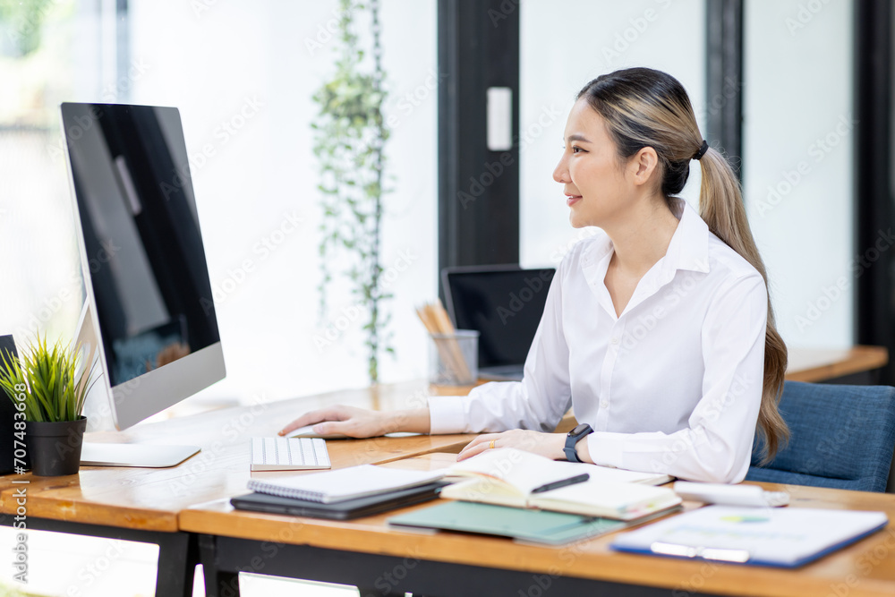 Asian Businesswoman Using laptop computer and working at office with calculator document on desk, doing planning analyzing the financial report, business plan investment, finance analysis concept.
Asian Businesswoman Using laptop computer and working at office with calculator document on desk, doing planning analyzing the financial report, business plan investment, finance analysis concept.