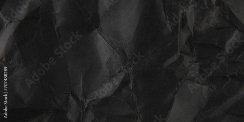 crumpled black paper texture background.