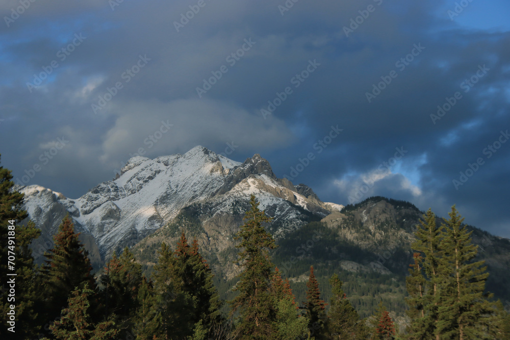 Sunlit Mountain with Dark Clouds