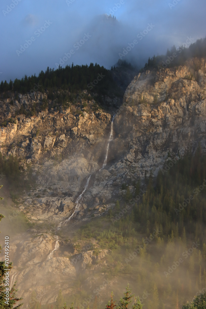 Fotografie Waterfall Through Golden Fog