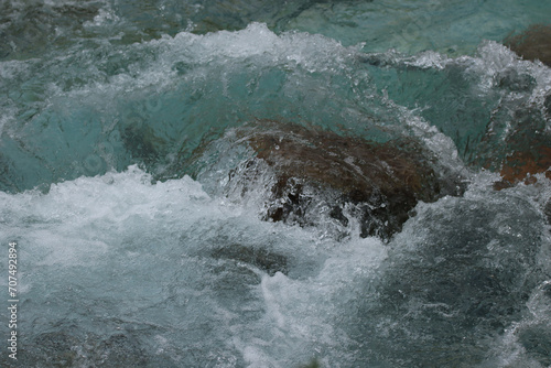Clear Water Rushing Over a Rock