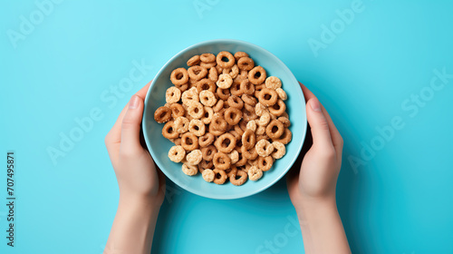 Hands holding Chocolate brown glazed rings for dry breakfast