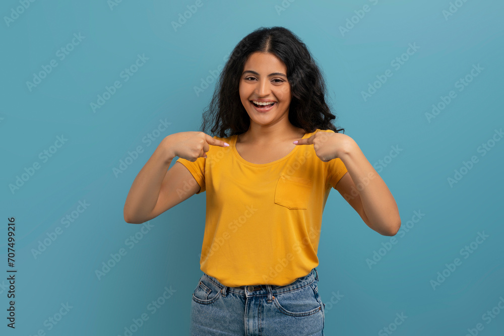 Overjoyed young indian woman pointing at herself and laughing Overjoyed young indian woman pointing at herself and laughing