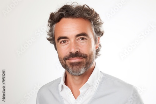 Portrait of a handsome middle-aged man in a white shirt.