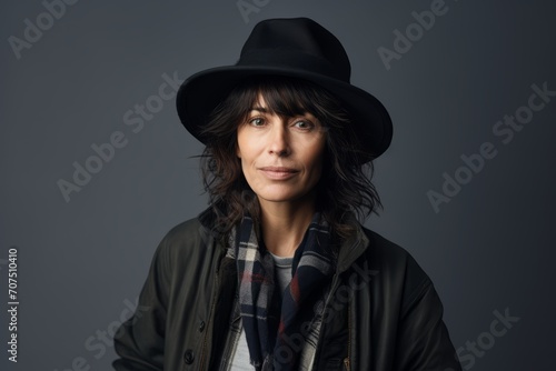 Portrait of a beautiful young woman in hat and jacket. Studio shot.