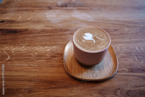 Heartwarming Latte Art in a Rustic Cafe Setting and wooden table. 