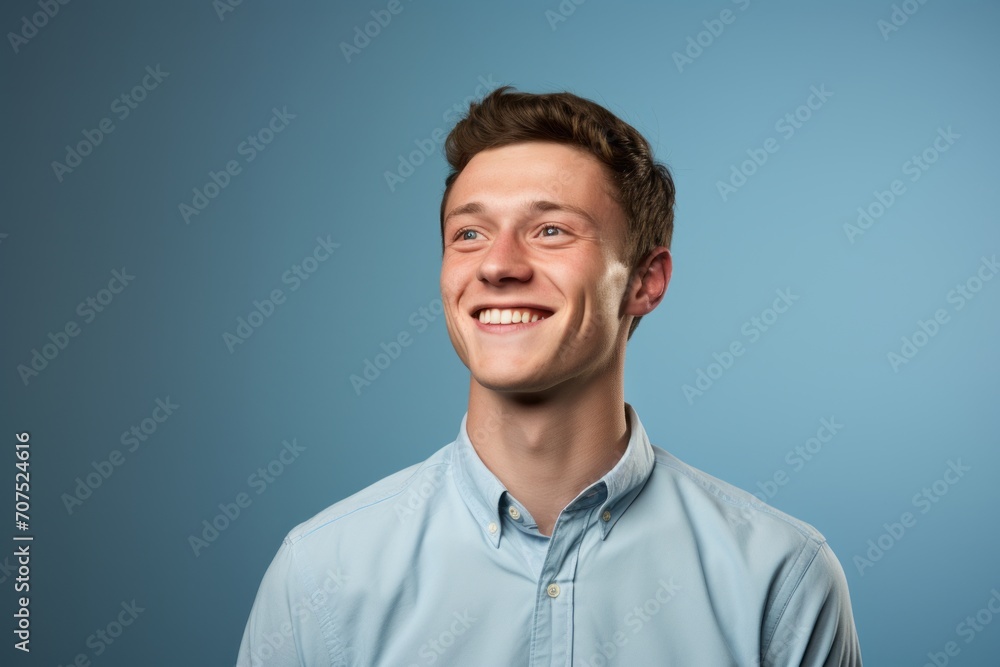 Portrait of a happy young man in blue shirt on blue background Portrait of a happy young man in blue shirt on blue background