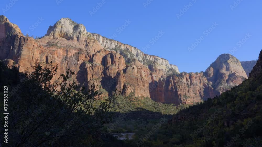 Establishing shot of mountains with red rocks in Emerald Pools Trail, Zion National Park, Utah, North America. Day time. ProRes 422 HQ. Establishing shot of mountains with red rocks in Emerald Pools Trail, Zion National Park, Utah, North America. Day time. ProRes 422 HQ.
