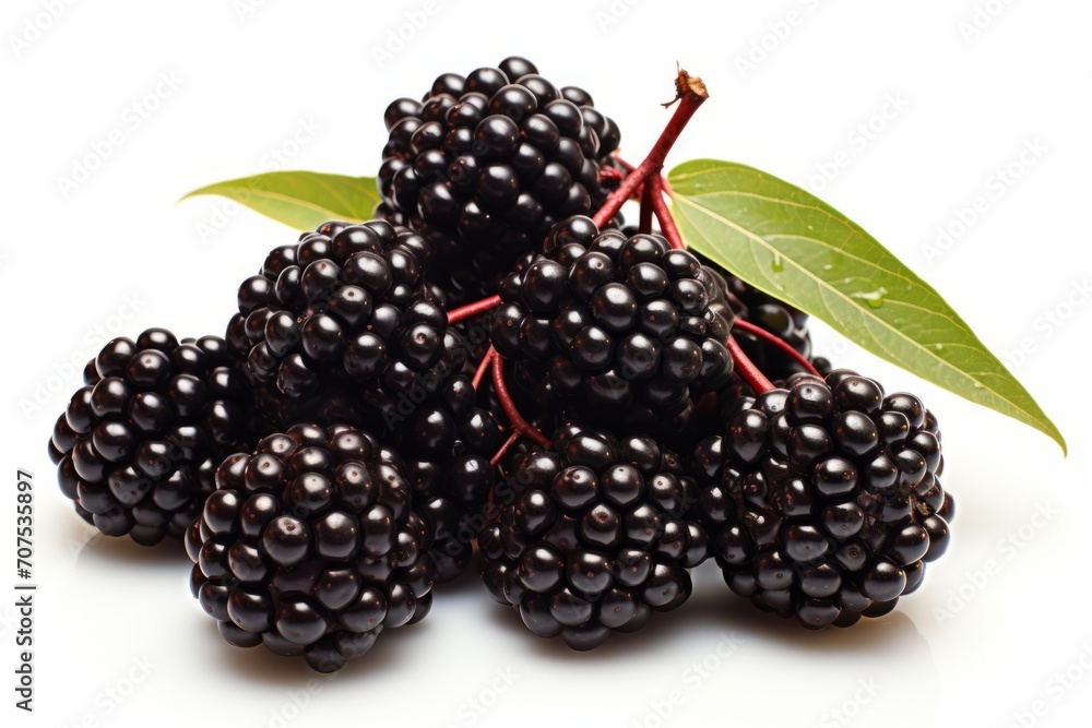 A heap of blackberries with leaves is shown on a white surface, looking as fresh as raspberries. A heap of blackberries with leaves is shown on a white surface, looking as fresh as raspberries.