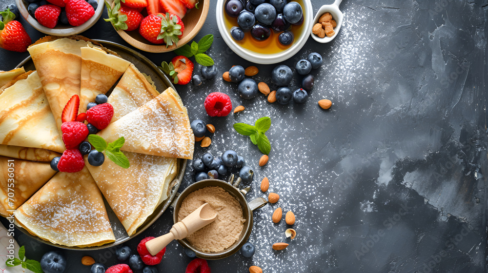 Fresh Crepes with Berries and Powdered Sugar
Crepes with a variety of fresh berries, powdered sugar, and honey on a dark textured background.
