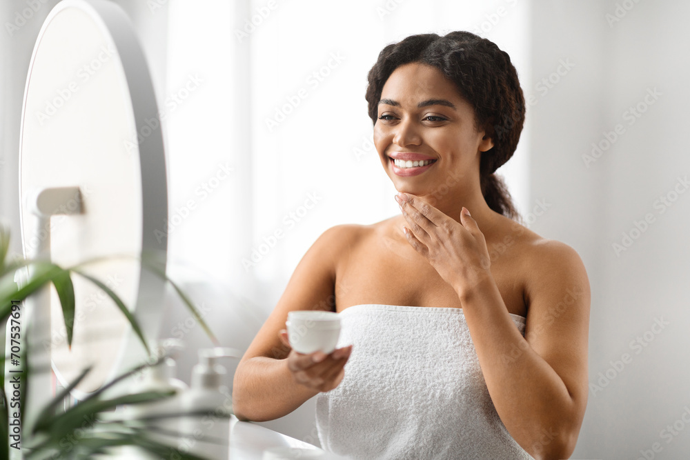 Beauty Rituals. Smiling Black Woman Applying Moisturising Cream On Face Beauty Rituals. Smiling Black Woman Applying Moisturising Cream On Face