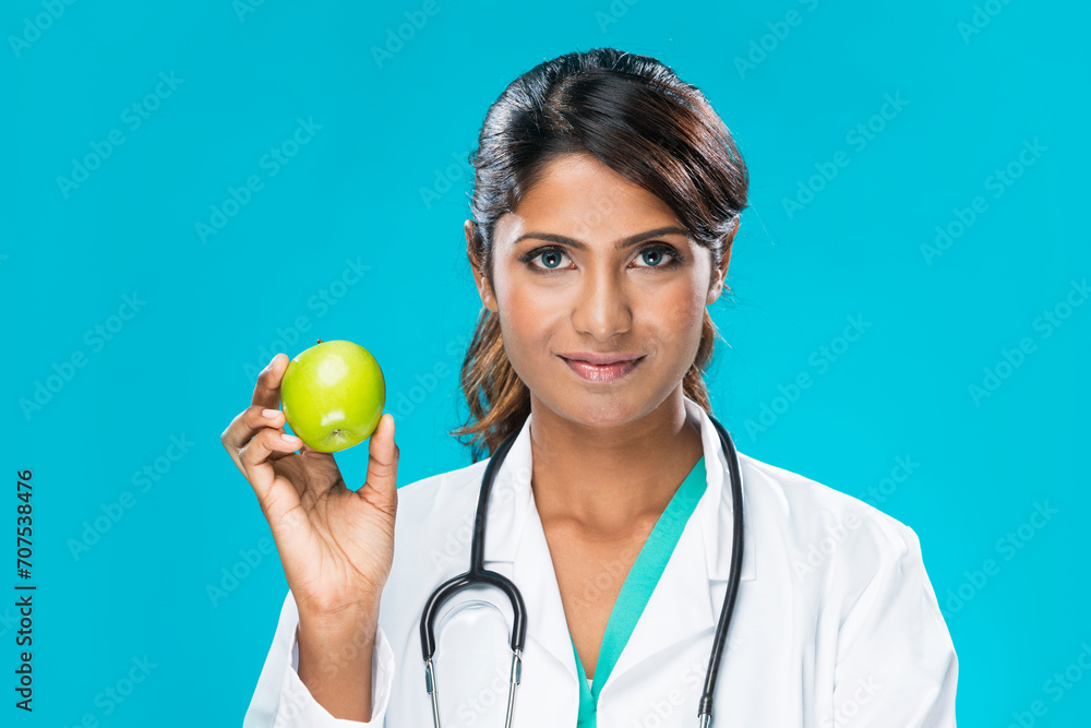 Indian doctor holding an apple. Indian doctor holding an apple.