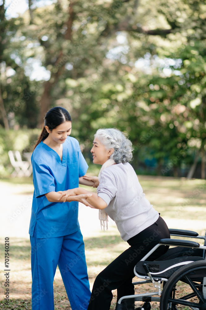 Asian young caregiver nurse support senior older female walking outdoors. Specialis doctor help and take care of elderly mature. Asian young caregiver nurse support senior older female walking outdoors. Specialis doctor help and take care of elderly mature.