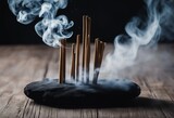 Smoke from incense sticks on a empty black stone table with black background High quality photo