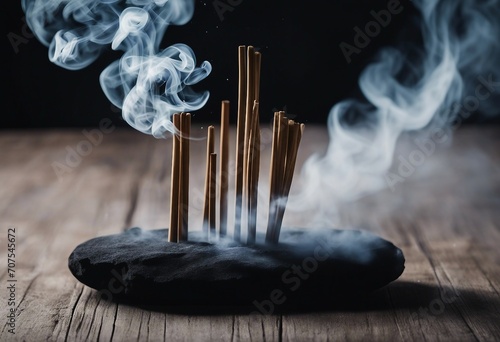 Smoke from incense sticks on a empty black stone table with black background High quality photo photo
