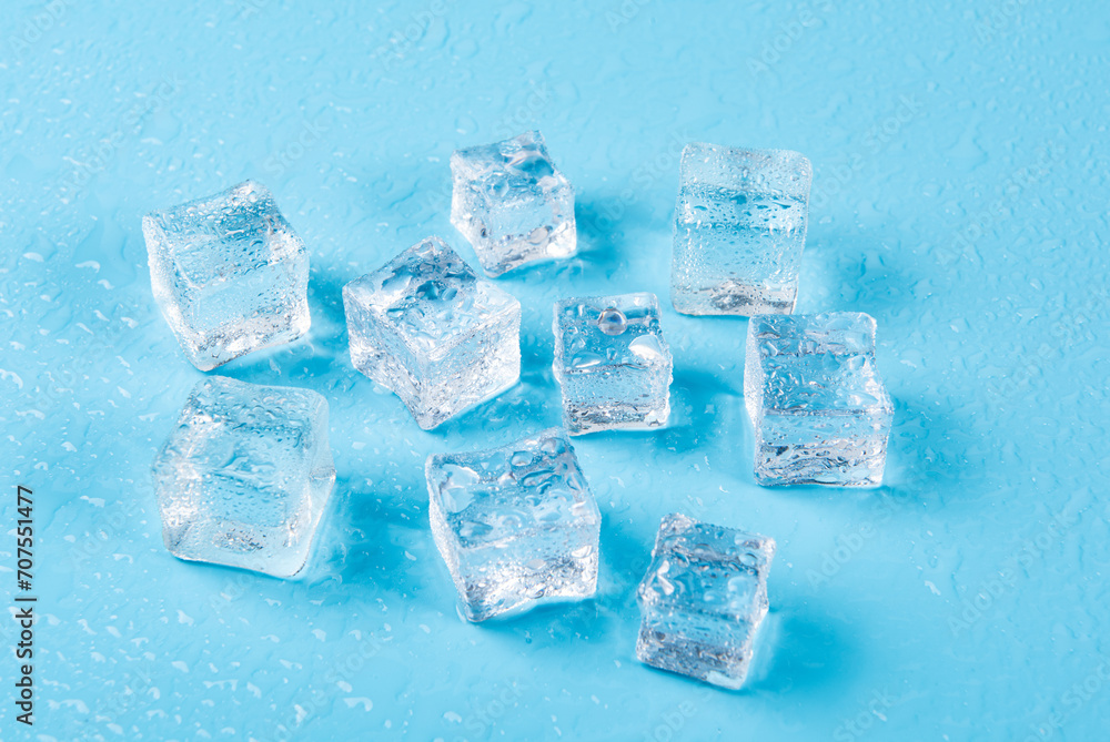 Ice cubes with water drops on a blue background. Ice cubes with water drops on a blue background.