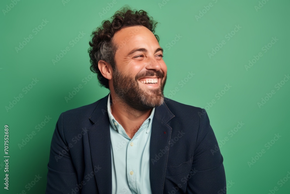 Portrait of a happy young man smiling at camera against green background Portrait of a happy young man smiling at camera against green background