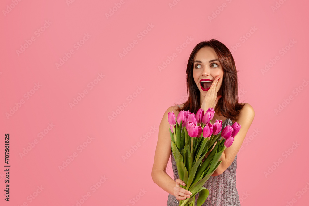 Surprised and delighted woman in a sparkly dress holding a bouquet Surprised and delighted woman in a sparkly dress holding a bouquet