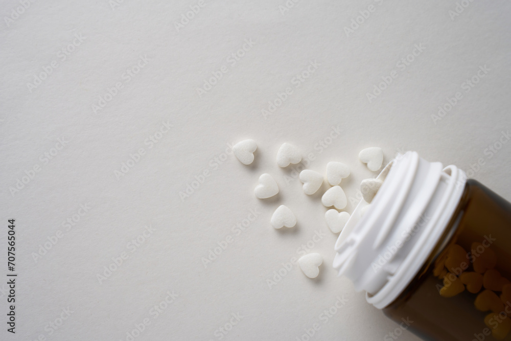 Heart shaped pills on a white background with copy space Heart shaped pills on a white background with copy space