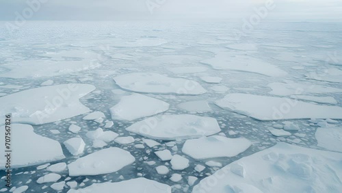 The once pristine white landscape is now a chaotic mix of freeting ice and murky waters, captured in stunning detail from an aerial perspective. photo