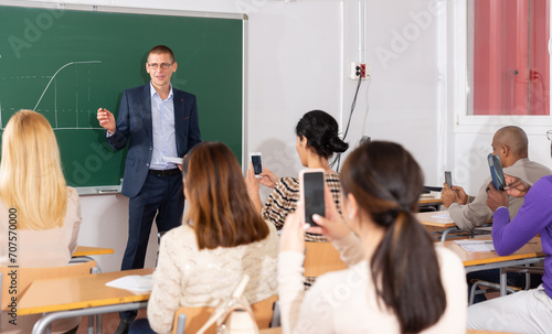 Teacher at the slate explains the lesson to the student