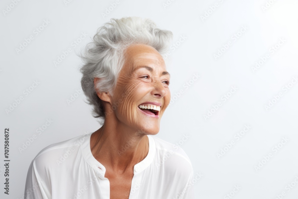 Portrait of happy senior woman laughing against white background. Elderly woman with grey hair. Portrait of happy senior woman laughing against white background. Elderly woman with grey hair.
