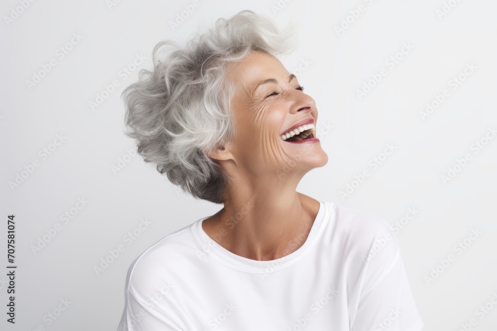 Portrait of happy senior woman laughing and looking up at copy space Portrait of happy senior woman laughing and looking up at copy space