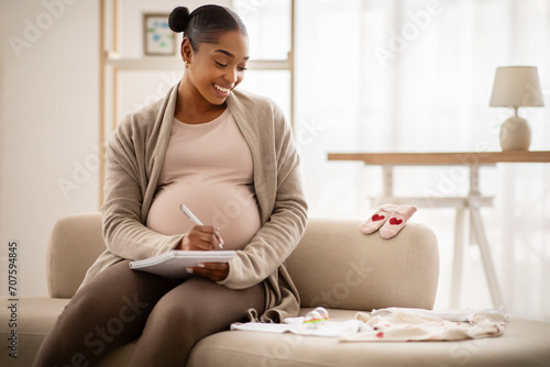 Pregnant black woman getting ready for the maternity hospital photo