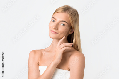 Beautiful Blonde Woman Touching Smooth Facial Skin Posing In Studio