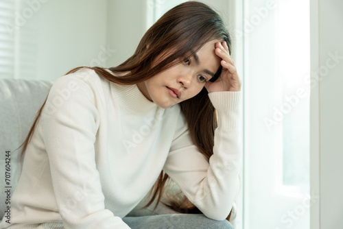  Depression and mental illness. Asian woman disappointed, sad after receiving bad news. Stressed girl confused with unhappy problems, arguing with boyfriend, cry and worry about unexpected pregnancy.
