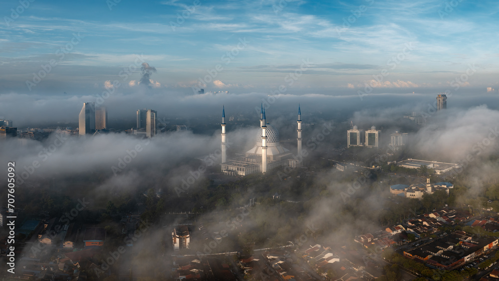 Aerial view of Shah Alam city skyline during low clouds and misty morning. Aerial view of Shah Alam city skyline during low clouds and misty morning.