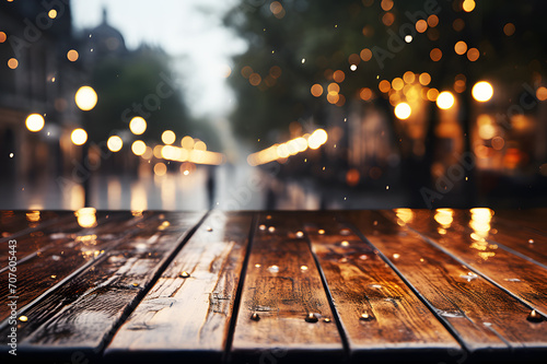 Wet empty dark brown wooden floor or table at middle of road. Raining and ground is wet. The trees and yellow lights are blurry in background. Realistic template pattern. 