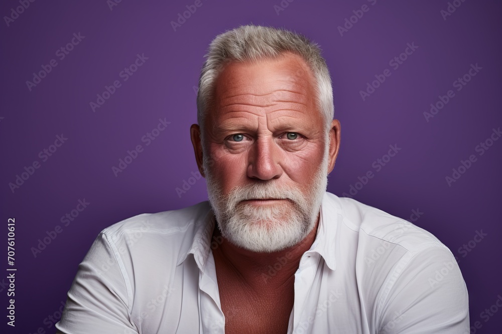 Portrait of a senior man with grey beard and mustache. Studio shot against purple background. Portrait of a senior man with grey beard and mustache. Studio shot against purple background.