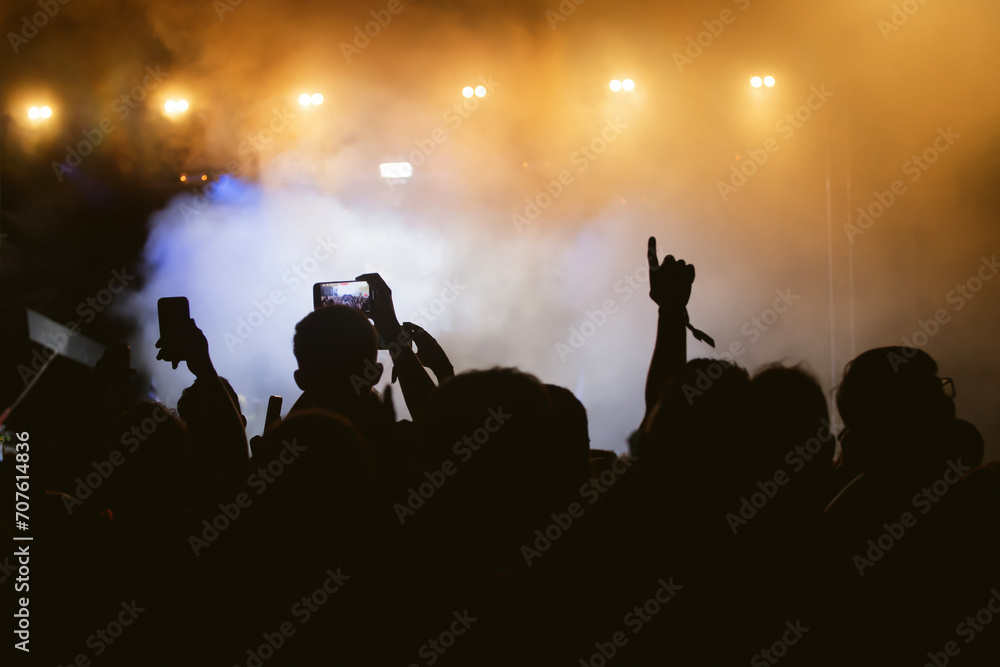 Abstract photo of crowd at concert and blurred stage lights.