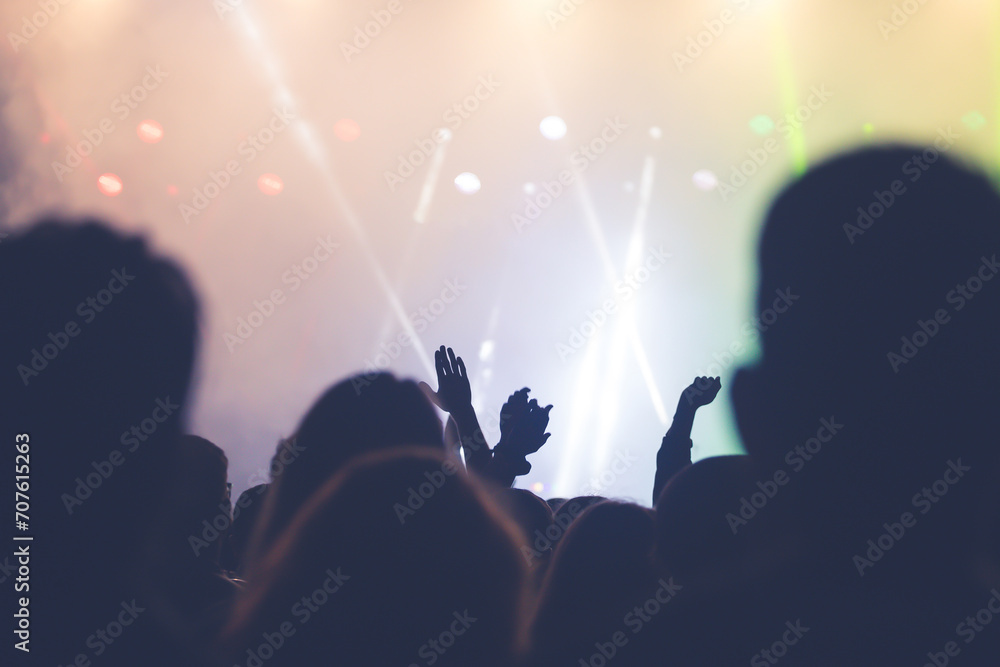 Abstract photo of crowd at concert and blurred stage lights.