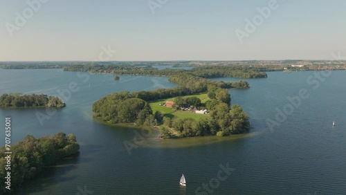 Princes Island Prinzeninsel Plön on warm sunny day with gentle water and sail boat photo