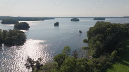 Boat sailing among sunny islands with serene waters photo