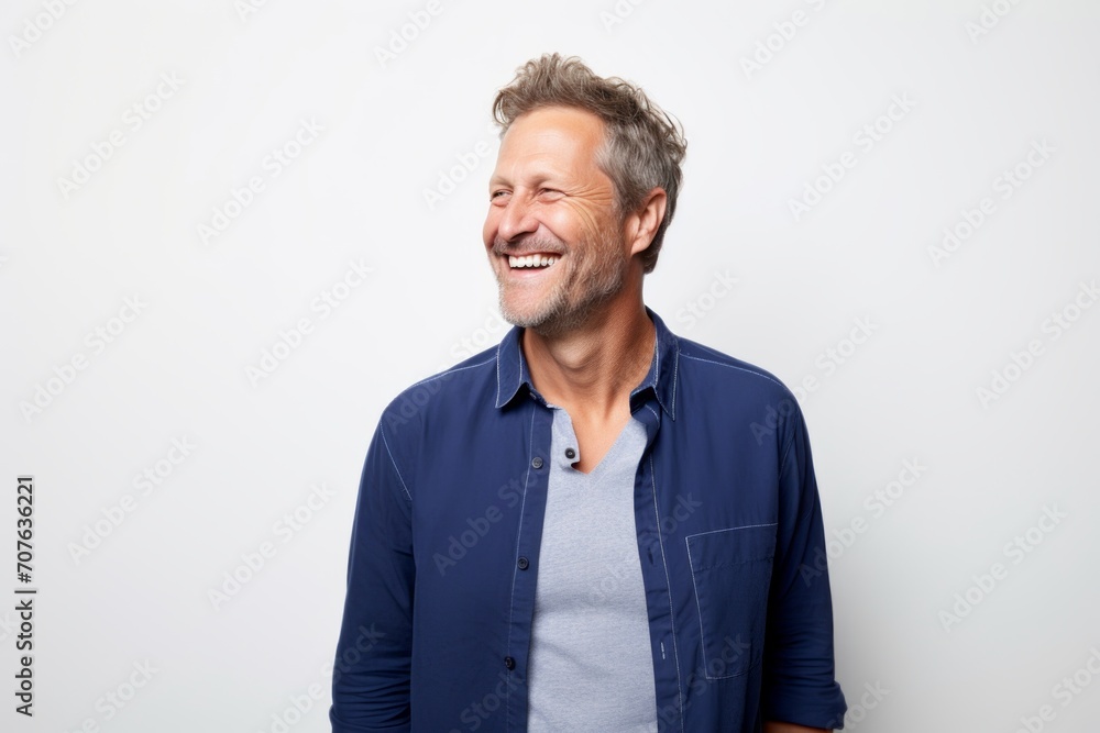 Portrait of a handsome senior man laughing against a white background. Portrait of a handsome senior man laughing against a white background.