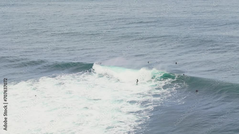 Surfer riding the face of small wave